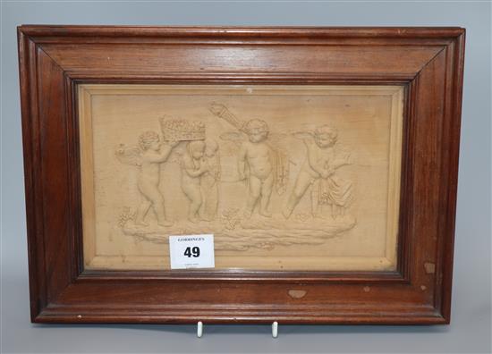 A 19th century walnut carving of putto, label on reverse 1st prize silver medal Peoples Palace, London 1889, 17 x 29cm excl. frame